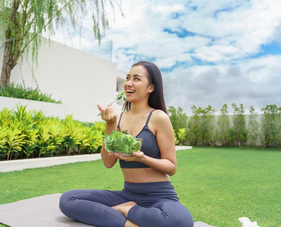 Woman enjoying healthy salad outdoors
